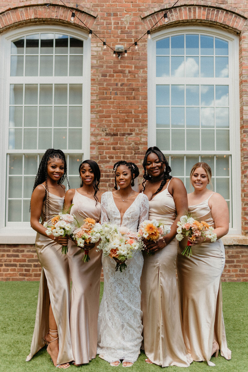 Bride with bridesmaids in matching champagne gold dresses