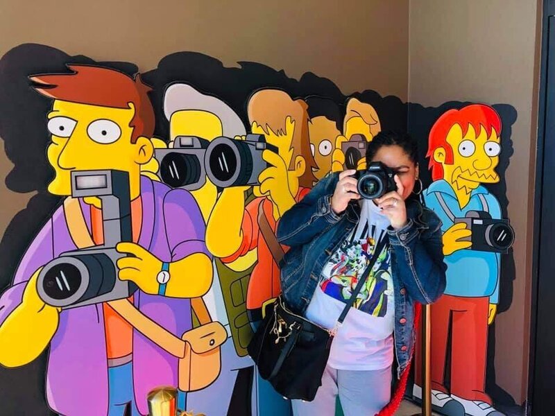 Woman taking a picture with The Simpsons photographers.