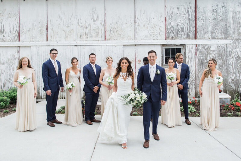 Bride and groom surrounded by their wedding parties
