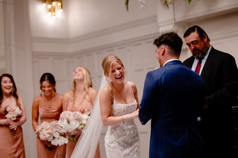 Bride laughs while getting married  at the W Chicago City Center.