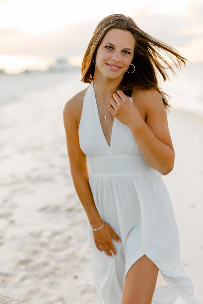 Image by South Shore senior photographer Christina Runnals  | Girl standing on beach in white dress