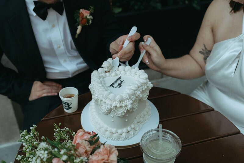 bride and groom having cake to celebrate after eloping shot by Elsie Goodman Photography | NYC Elopement Packages