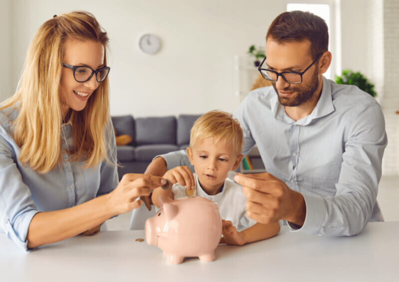 parents and child using piggybank