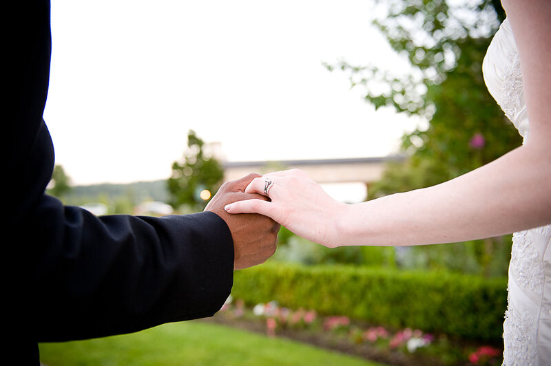 Bride and groom hold hands