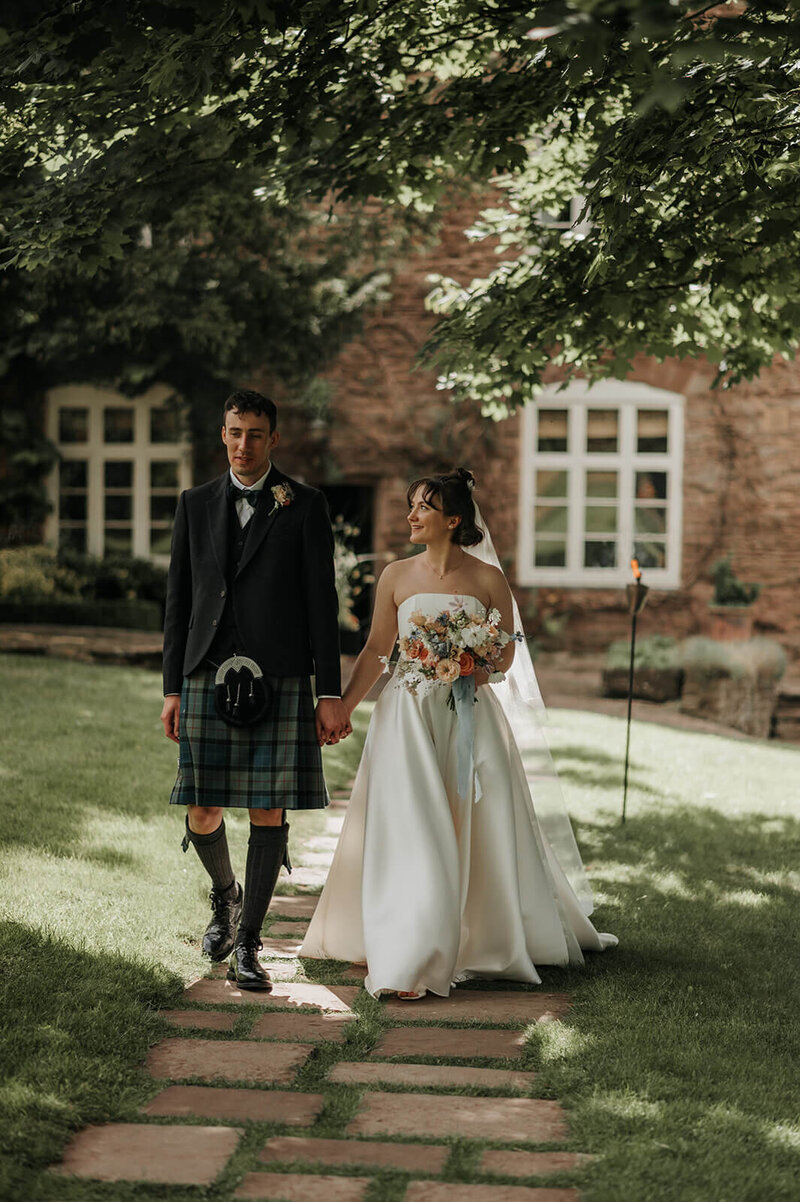 Bride and groom outside Dewsall Court