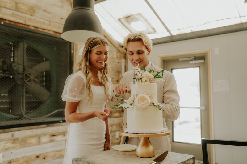 Bride and Groom cut the cake at Shade Home & Garden