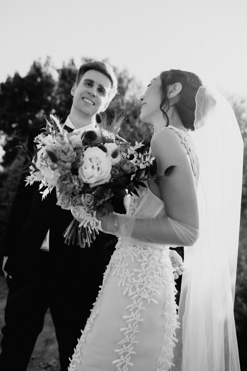 wedding couple with large bouquet in black and white