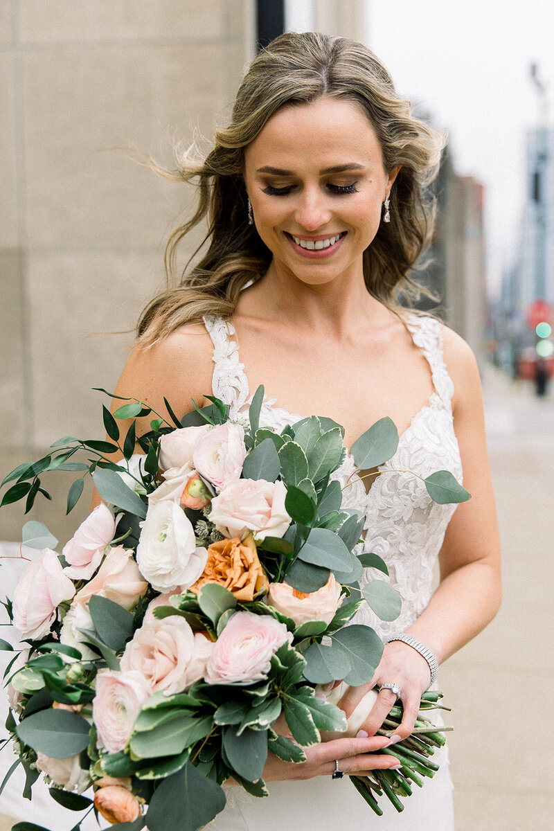bride cradling bouquet