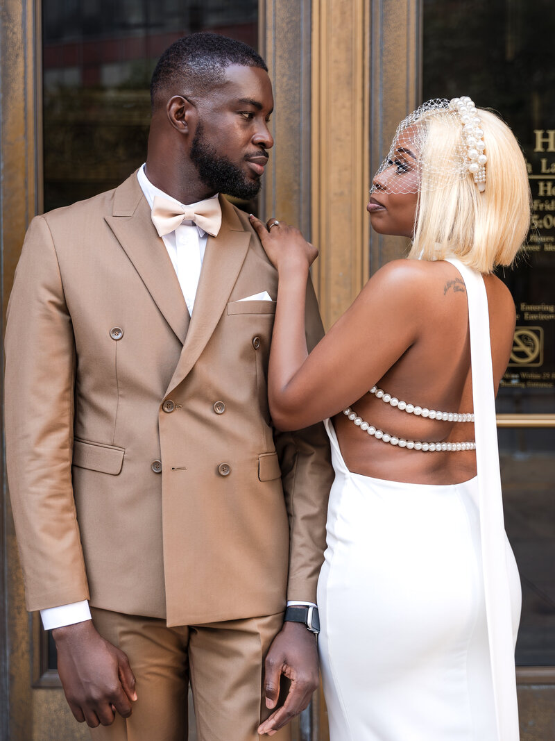 Couple shares a romantic kiss outside Chicago City Hall after their elopement, captured by Kesha Wright Photography.