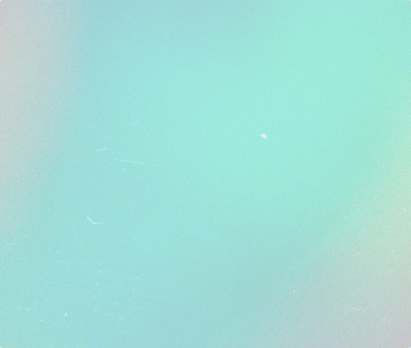 Gradient background showing hues of blue, green, yellow and red.