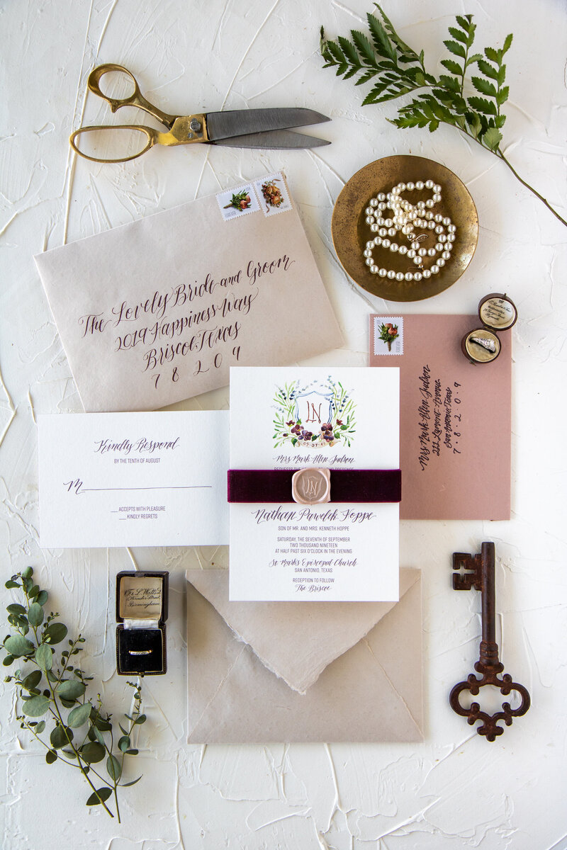 handmade paper escort cards with silk ribbon and champagne wax seal