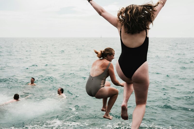 group jumping in water