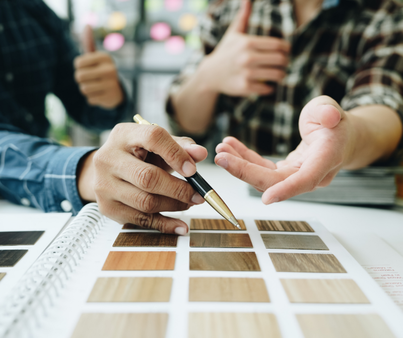 Two people reviewing wood grain options.