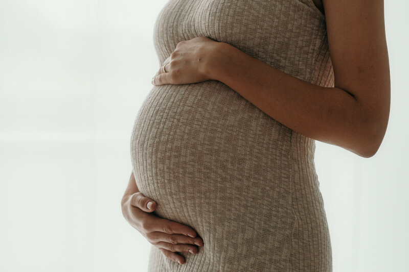 Closeup of a pregnant womans baby bump. Maternity Photographer Los Angeles.