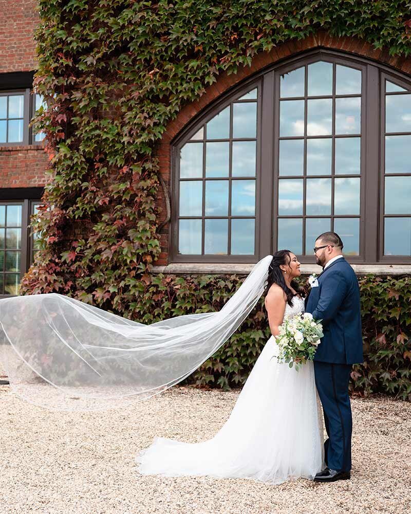 Dover Hall wedding photography of couple by ivy wall