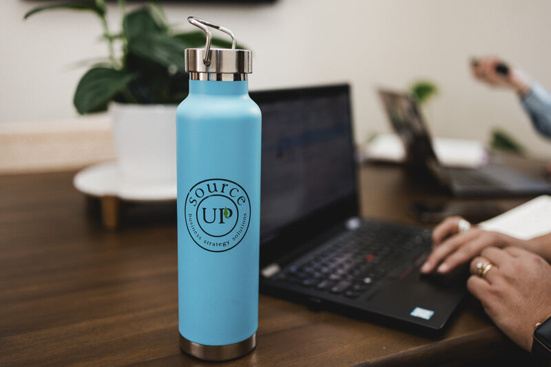 a water bottle with the SourceUp logo on it