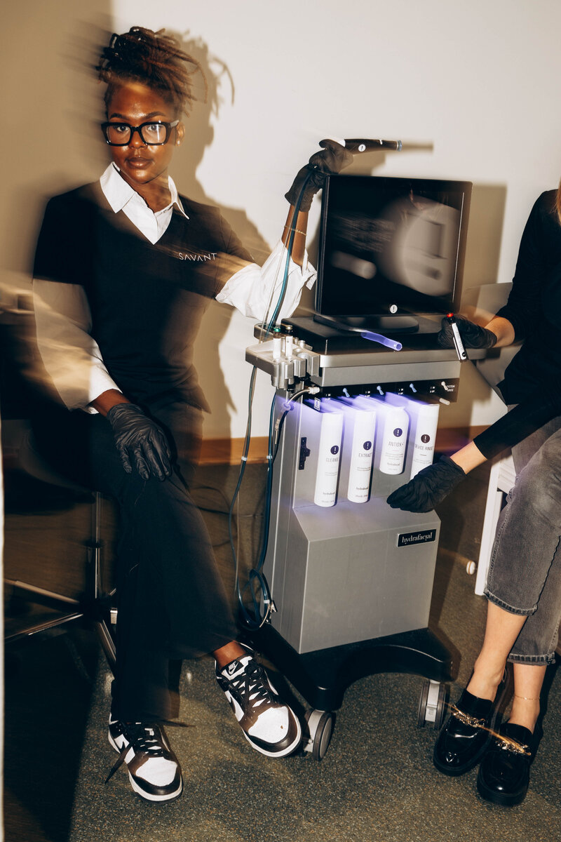 A student learning how to use a Hydrafacial machine, one of the advanced skincare treatments at Savant Aesthetics Institute.