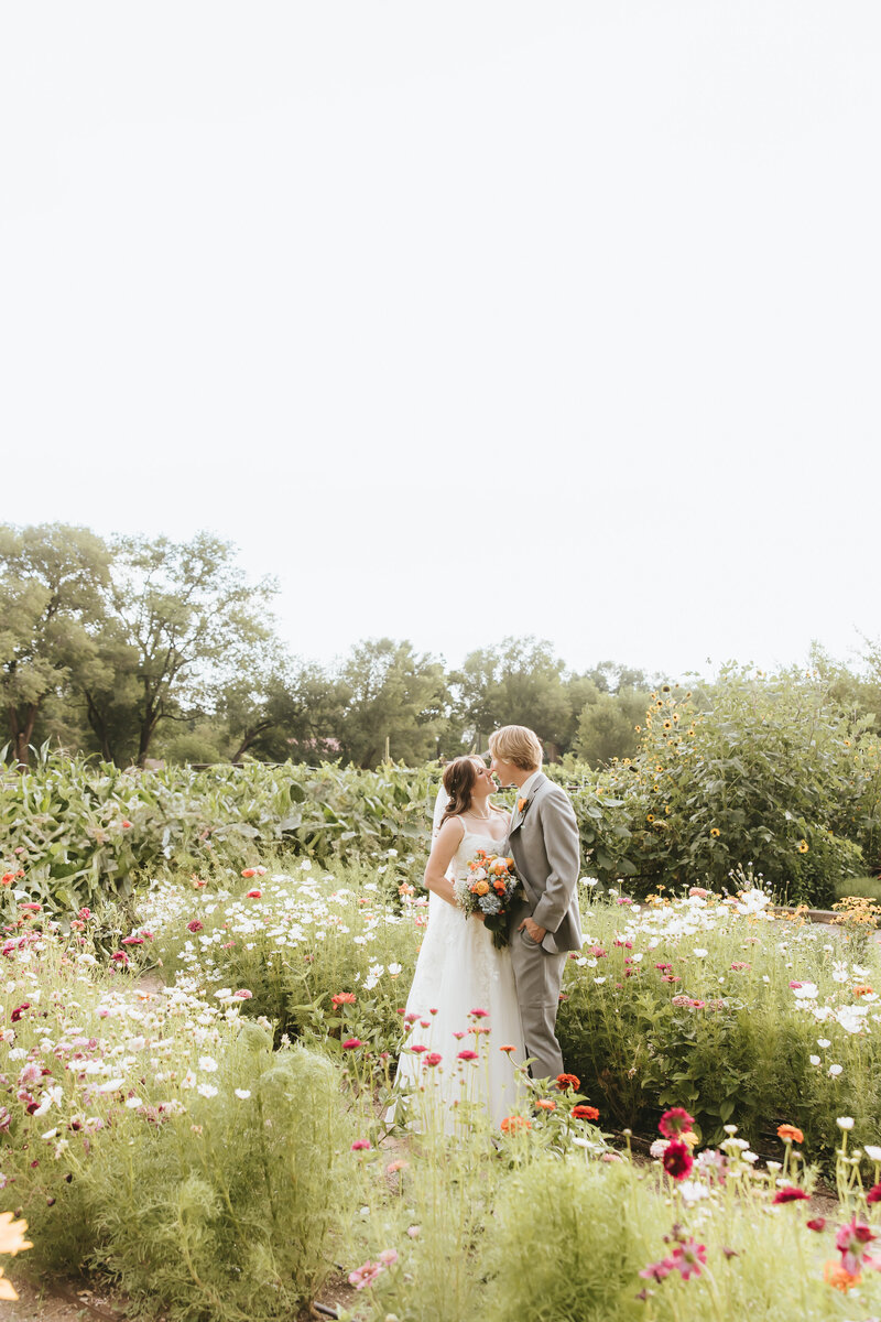 Bride and groom in the garden kissing
