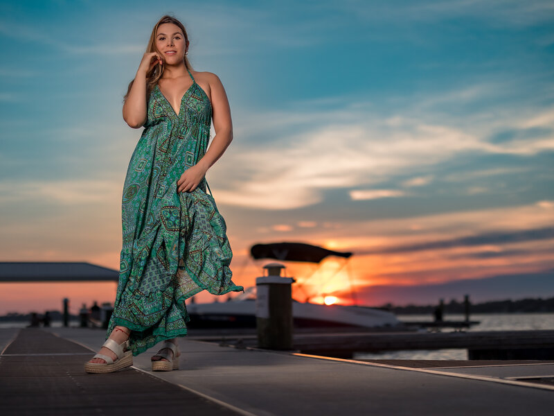 Photograph with a woman  in front a mt dora sunset.