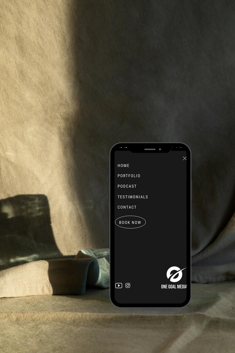 Clean and intuitive website menu for One Goal Media, including sections like Home, Portfolio, Podcast, Testimonials, and Contact, designed to engage and guide users through their social media agency's offerings