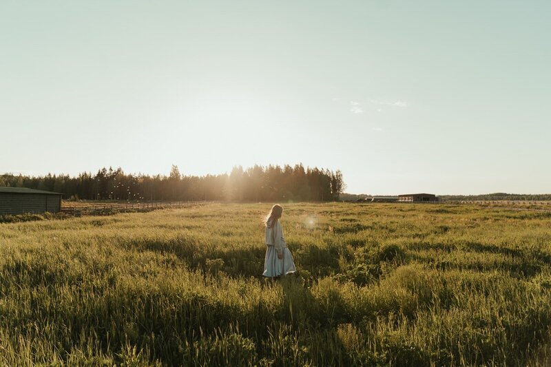 woman walking through a field