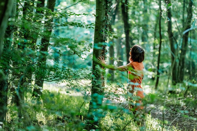 A sophrologist connecting with nature in the woods.
