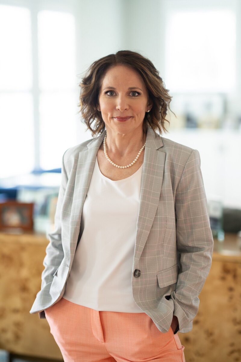Rebecca standing in her office smiling