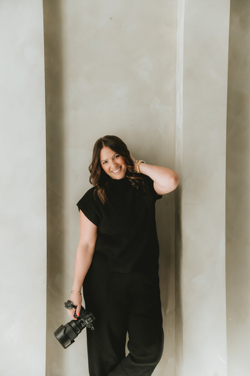 woman holding camera posing at Lighthouse Studios