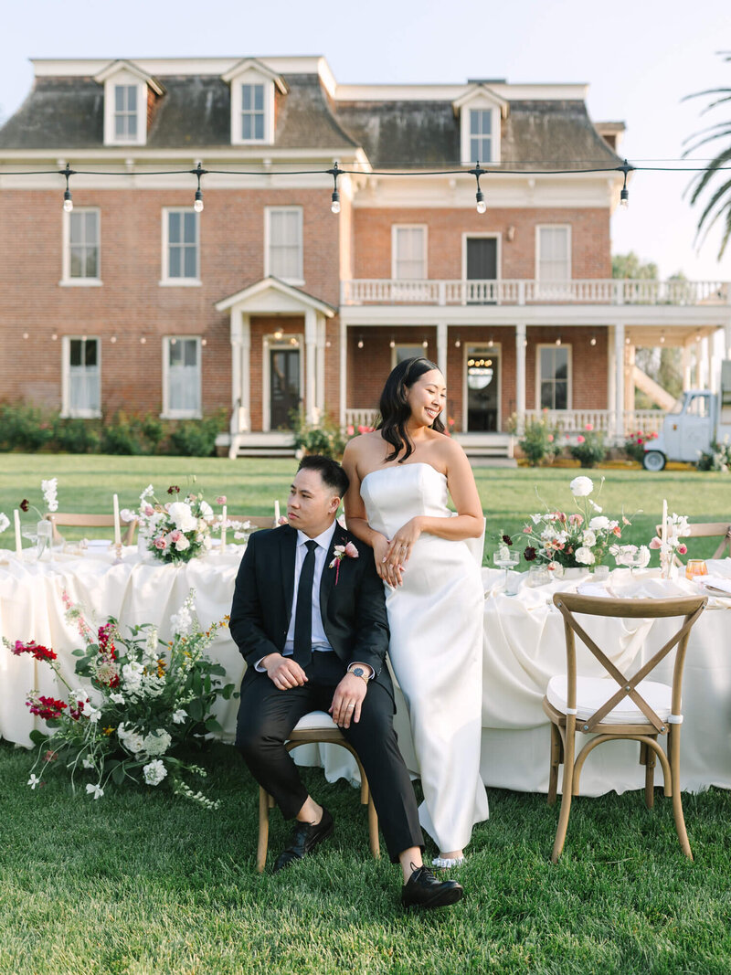 wedding portrait photography of bride and groom at reception table from the barton house of redlands