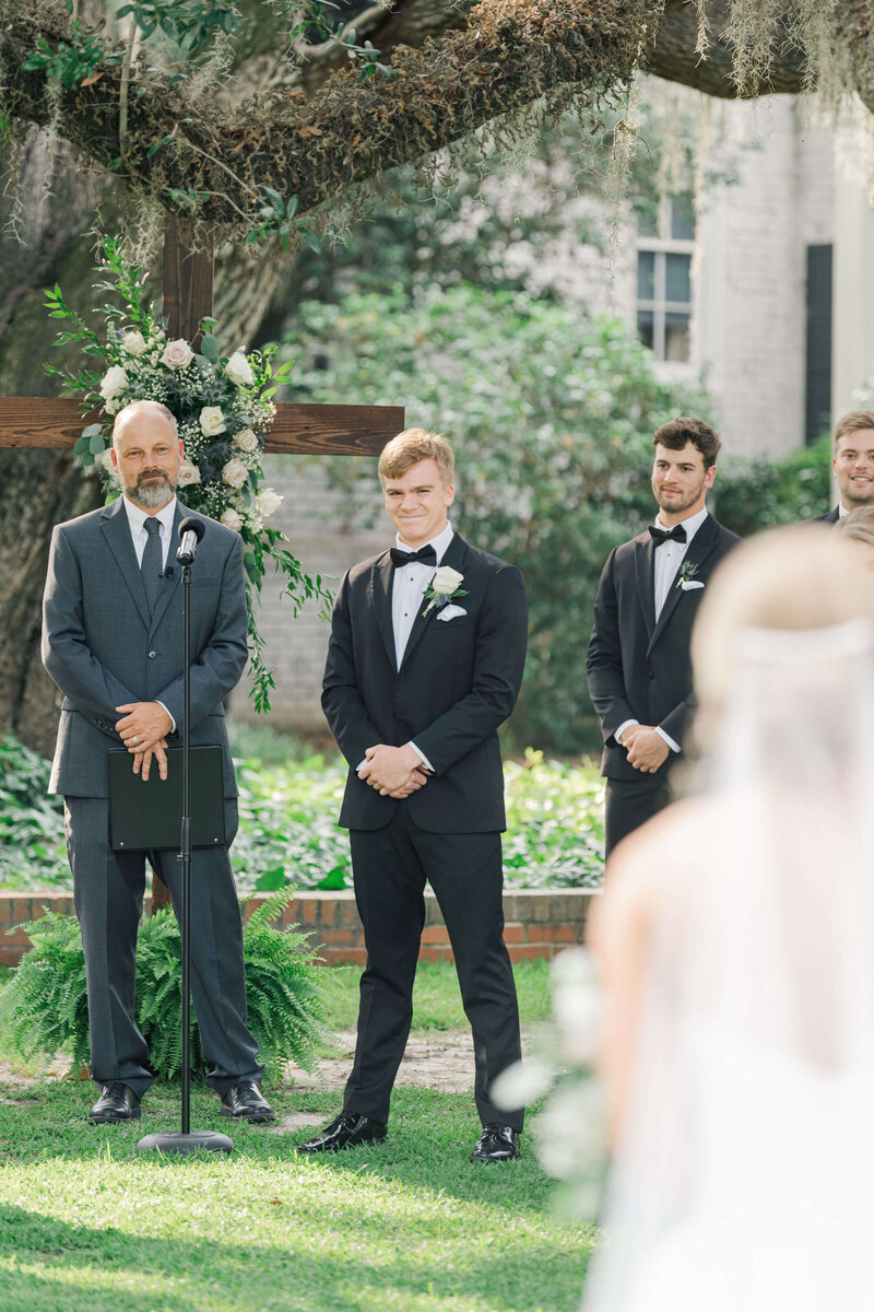 Groom watching as bride walking down the aisle