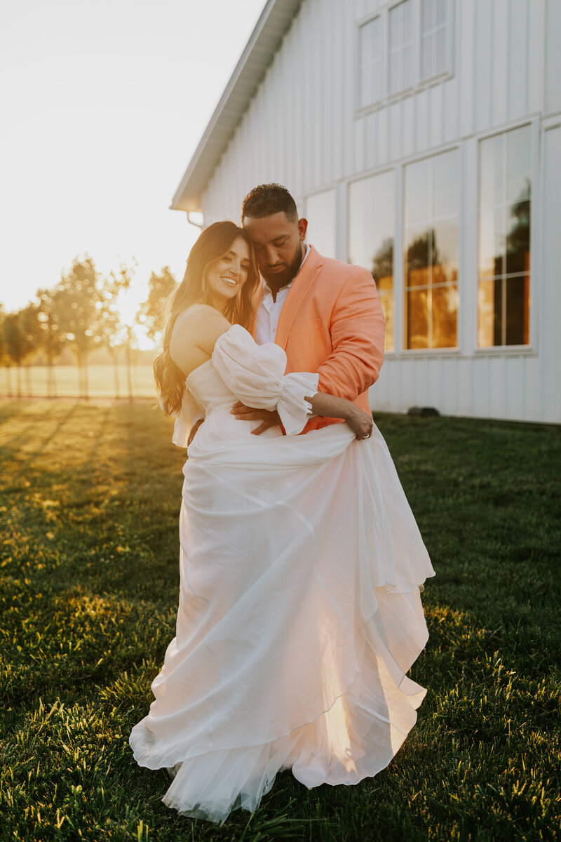 Golden hour summer wedding portraits of a bride in her Vera Wang wedding dress and groom in his Ralph Lauren suit