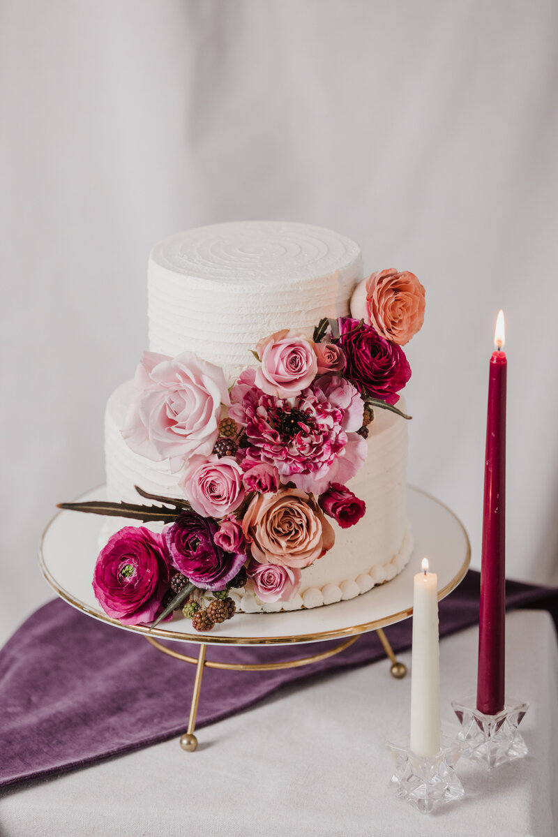 Wedding cake with purple and pink florals design by Jessamine floral and events, New Jersey floral designer