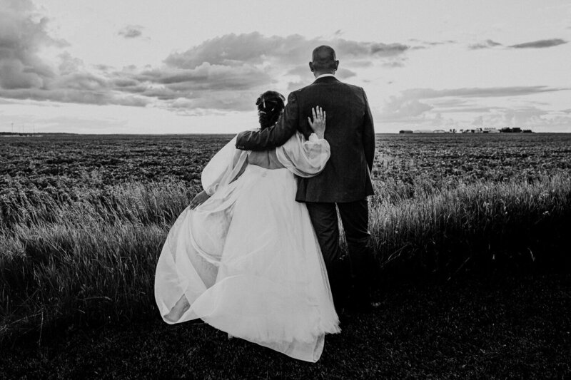 Bride and groom at sunset in the prairie field