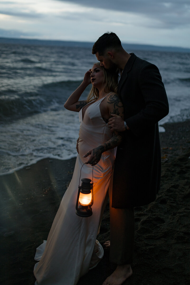 bride and groom on beach with lanterns for alaska beach wedding