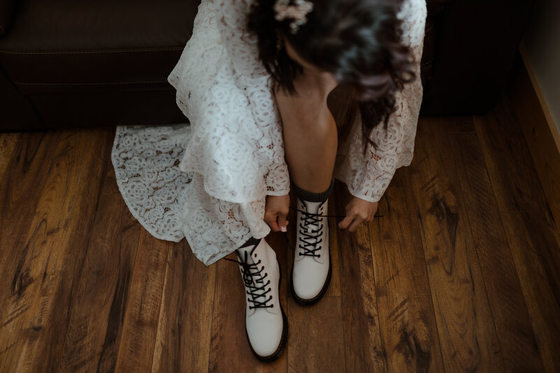 bride lacing up boots