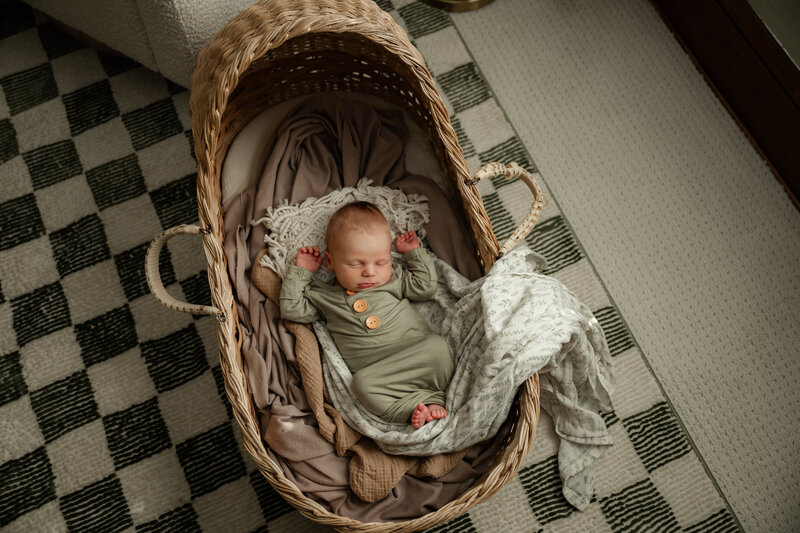 Baby in newborn bassinet during a Tacoma Newborn Photography photoshoot