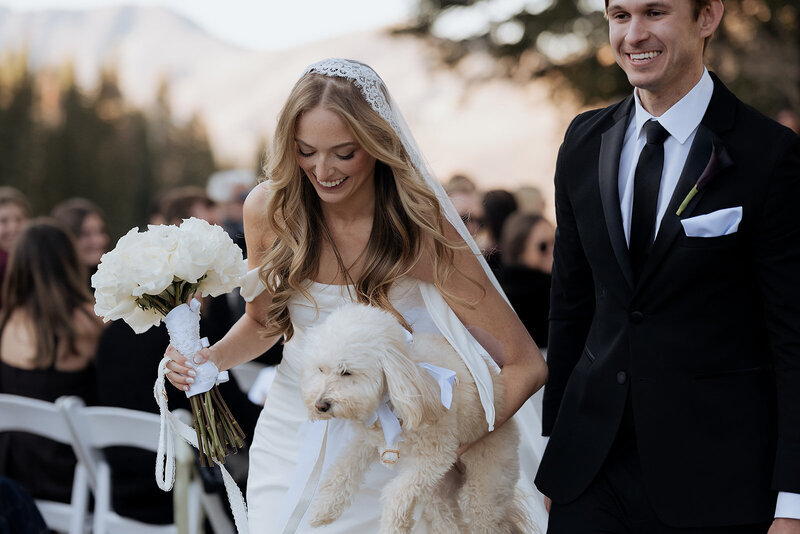 Couple Just married walking out of their ceremony in the utah mountains.