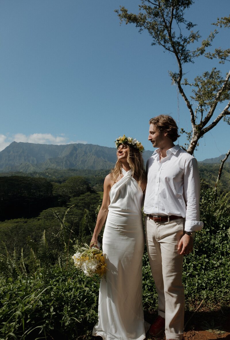 bride and groom standing on kuilau ridge trail