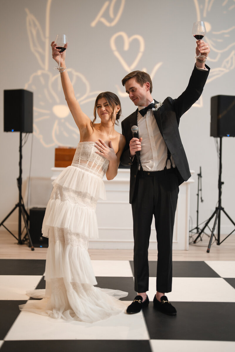newlyweds raise a toast to their wedding guests and vendors during the wedding reception