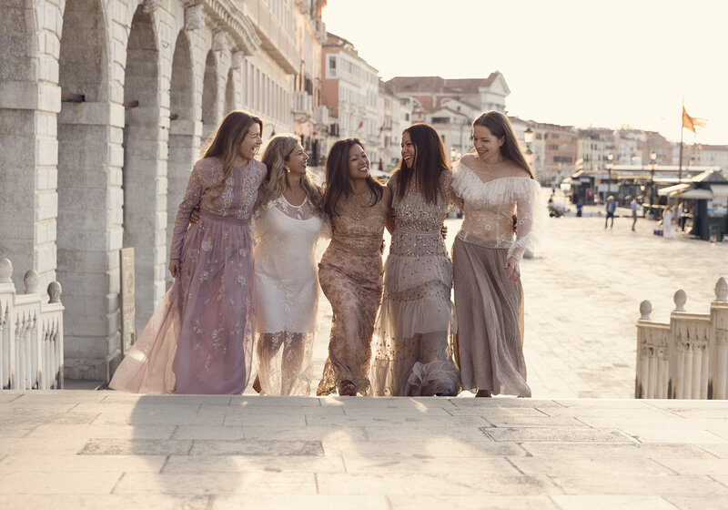 Group portrait of a hen party at sunrise in St Marks Square, Venice. Taken by womens empowerment photographer Claire Howes.