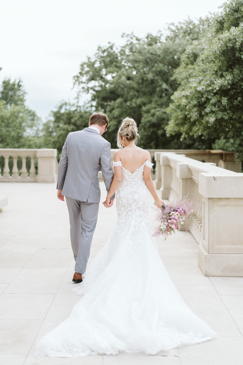 a bride and groom walking the steps at the Olana in Texas