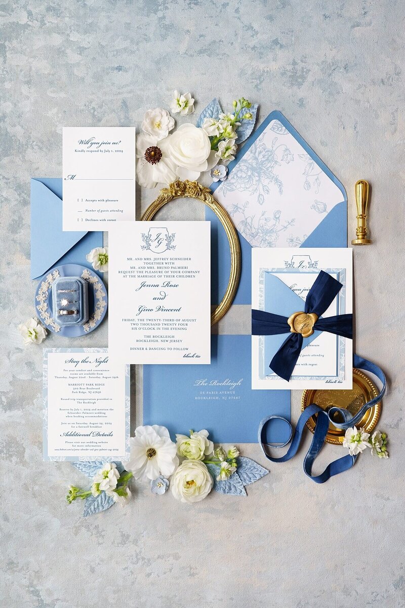 Classic blue NJ wedding invitations with florals, monogram, silk ribbon, and champagne gold wax seal