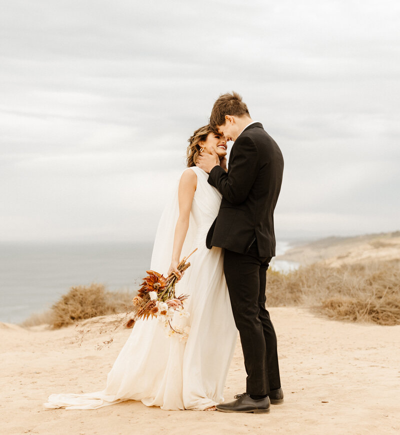 bride and groom at cliffside Southern California elopement