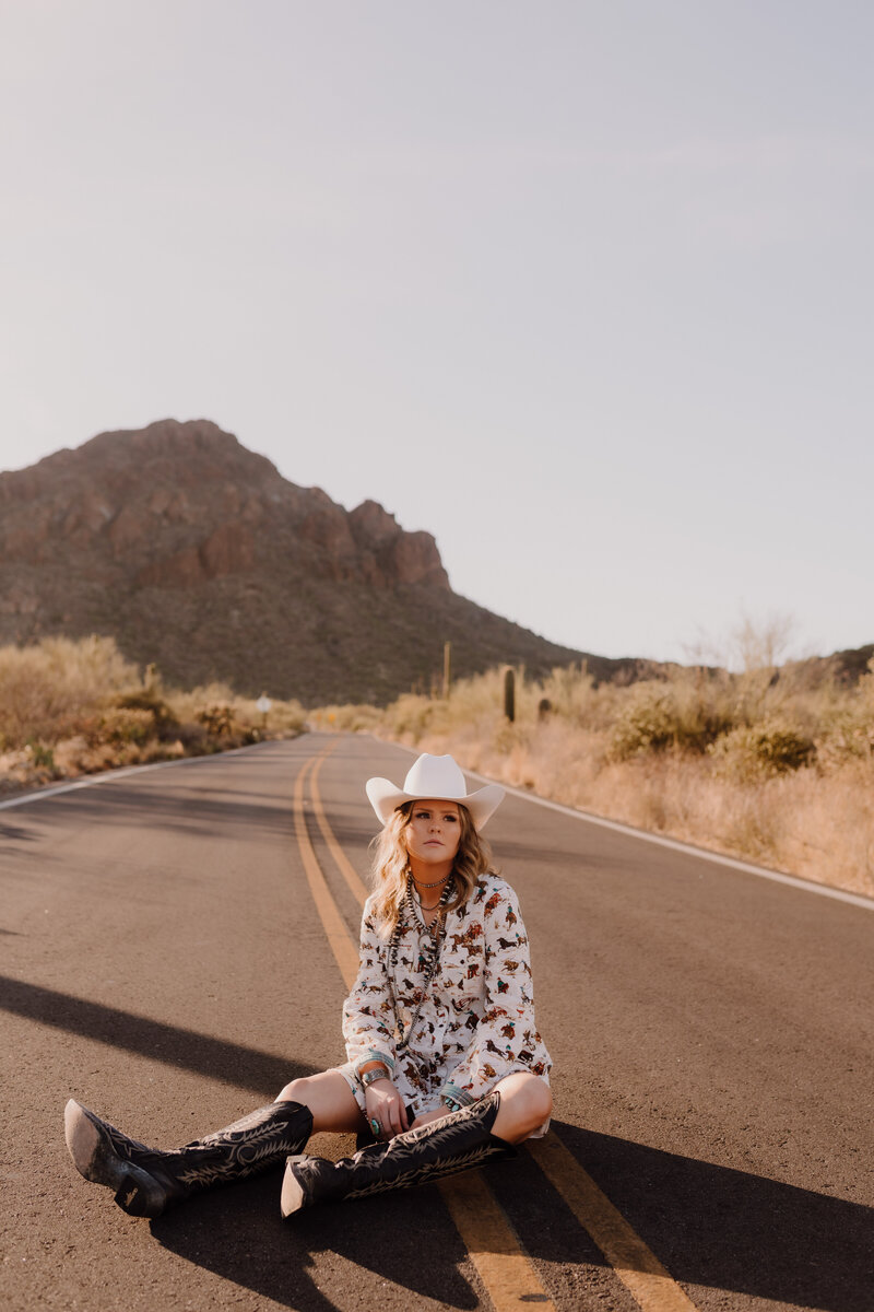 woman sitting in road posing