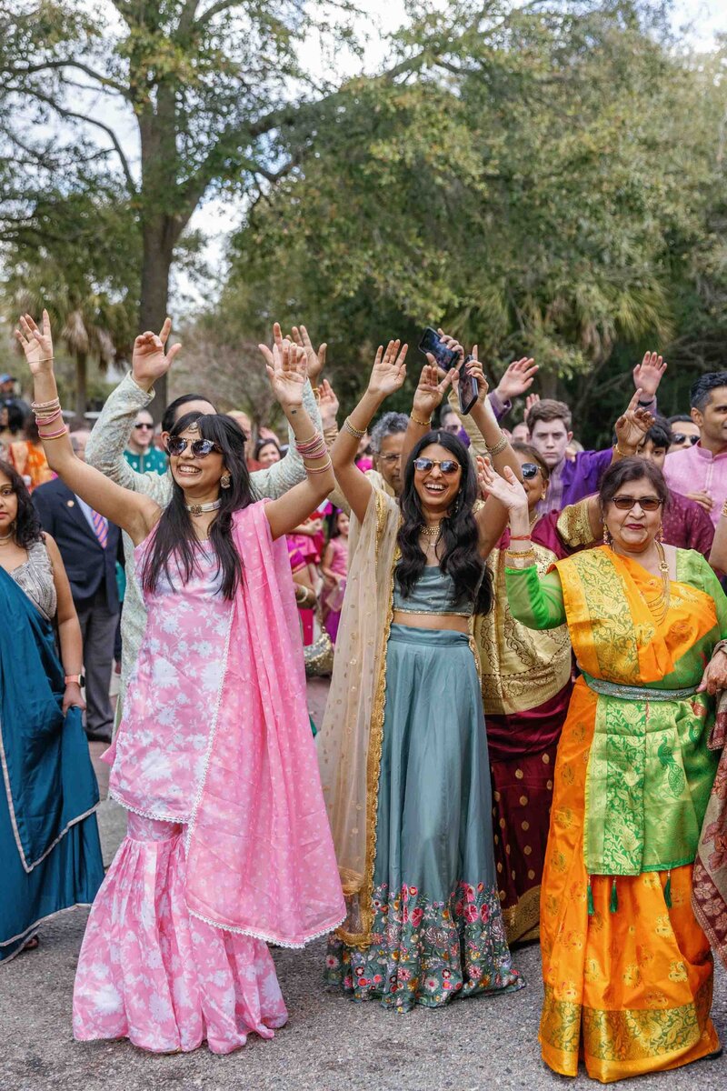 photo of bride + groom walking through sand dunes on their wedding day