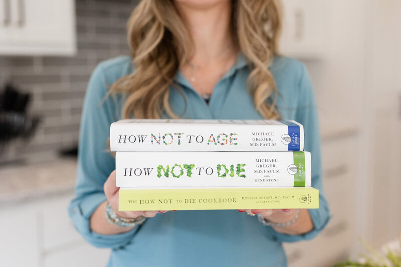 Amy with a stack of health books