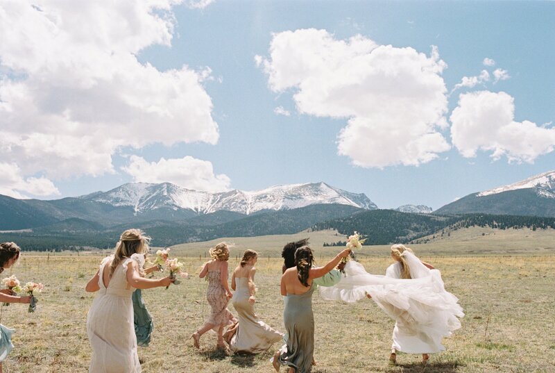 bride and groom walking along banks of the madison river in big sky montana