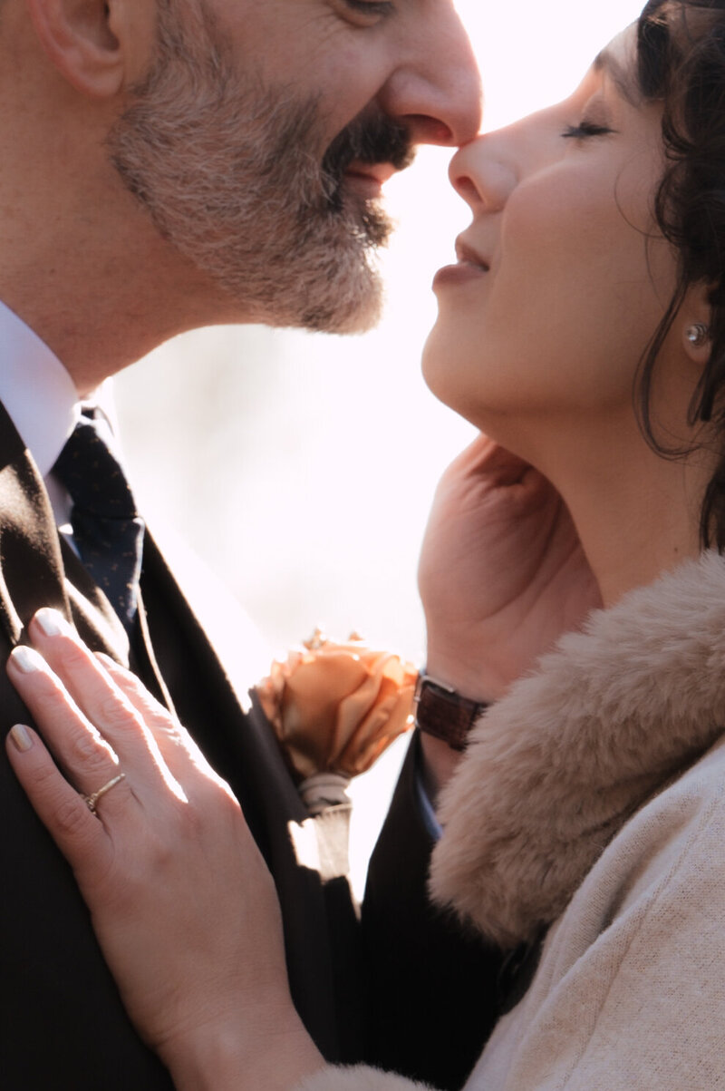 Couple sharing a kiss on a nature trail in Williamsburg, Virginia