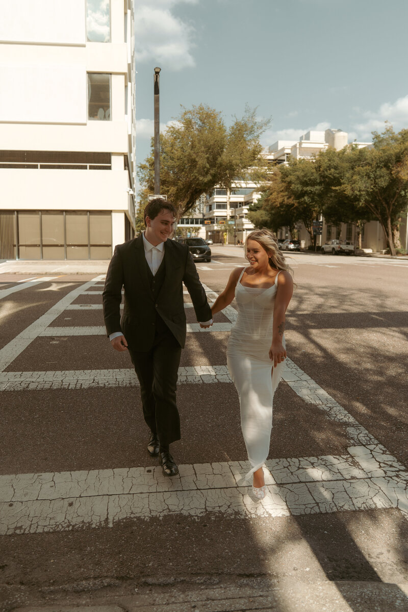 Close-up of tattooed couple wearing pink sunglasses sharing an intimate moment under a decorative parasol