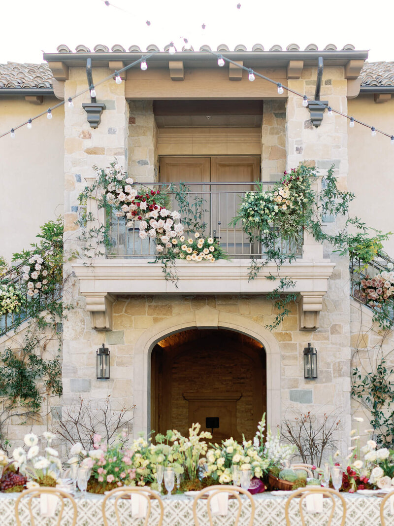 reception table filled with flowers facing the iconic stairs at monserate winery in fallbrook